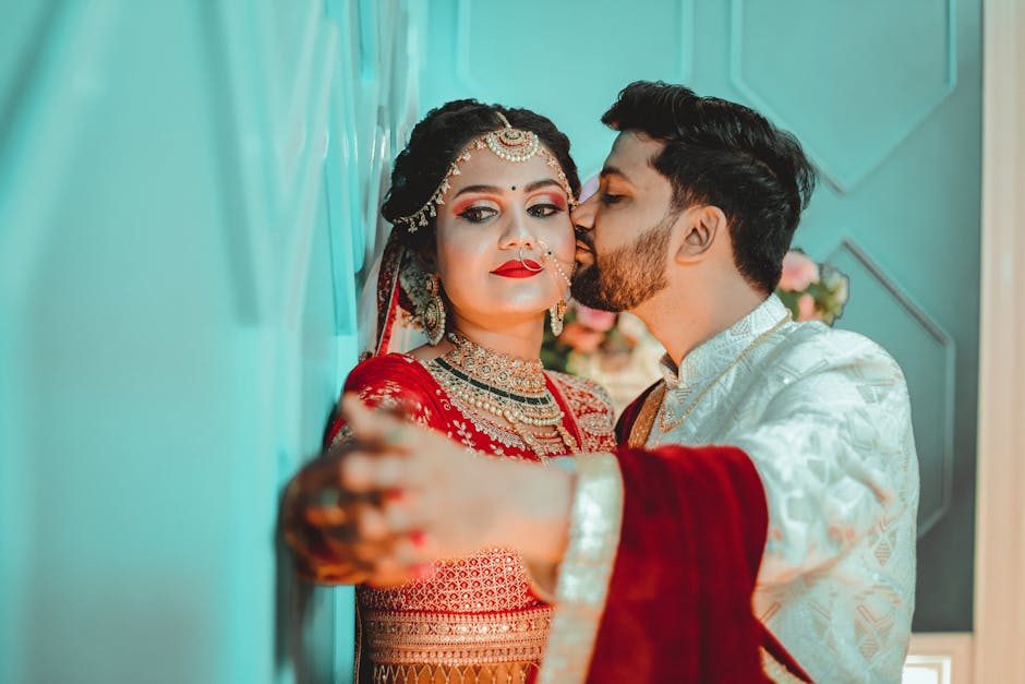 A Man Kissing the Bride while Wearing Traditional Clothes