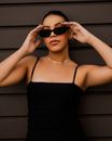Woman in Black Spaghetti Strap Top Wearing Black Sunglasses