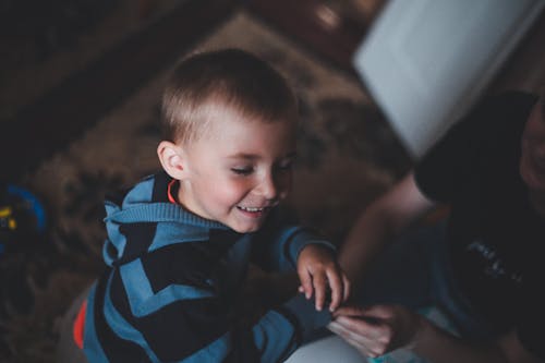 A Boy in Striped Jacket Smiling