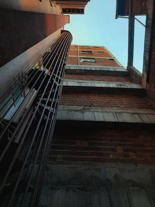 Free Brick building exterior captured from a low angle with dramatic perspective. Stock Photo