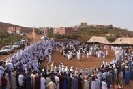 Large outdoor gathering in a Moroccan village, showcasing cultural and traditional attire.
