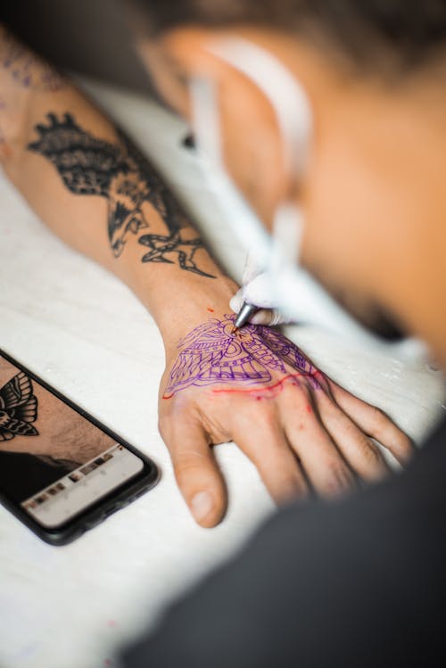 Person Getting a Tattoo on the Hand