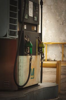 Old and shabby gasoline pump at an abandoned gas station in Venezuela.