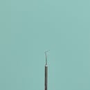 Dental Scaler on Turquoise Background