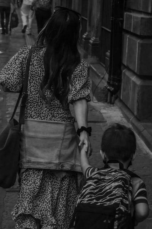 Back View of a Woman Holding Hands with her Son