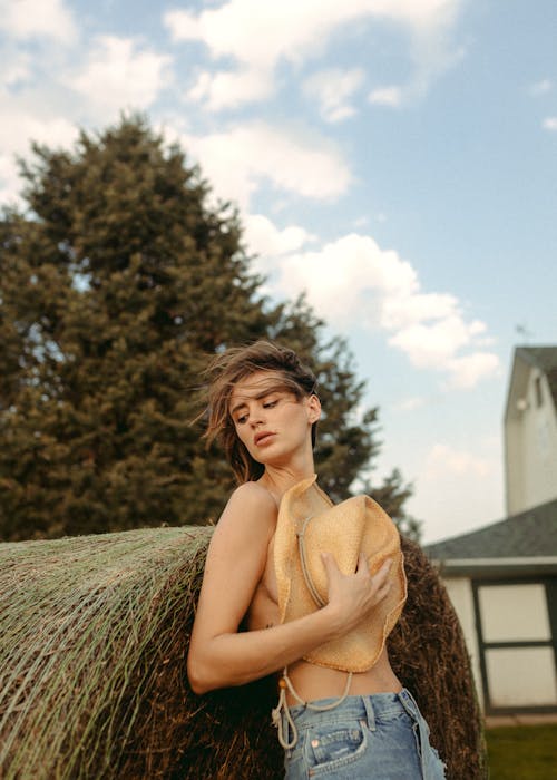 Topless Woman covering her Chest with Cowboy Hat 