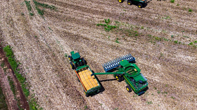 An Aerial Photography Of A Tractor On Cornfield