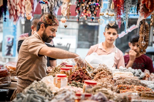 A vibrant street market scene with a vendor selling assorted goods to customers. Candid interaction and colorful display.