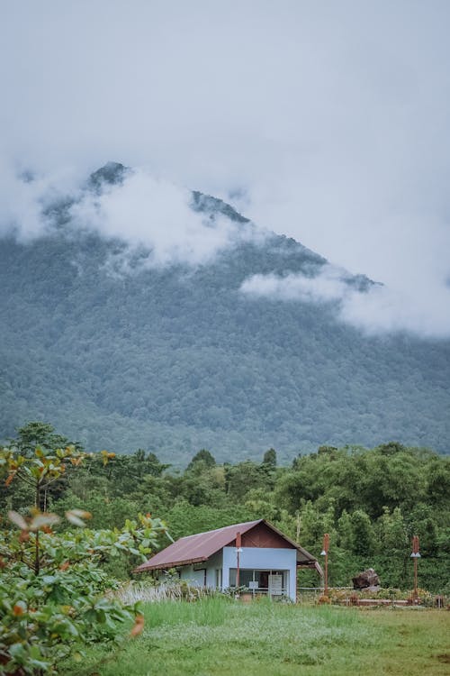 A House Near the Mountain Under the Cloudy Sky