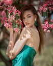 Woman in Teal Dress Holding Pink Flowers