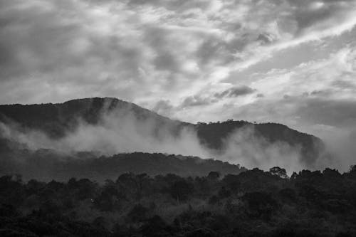 Grayscale Photo of Mountain With Clouds