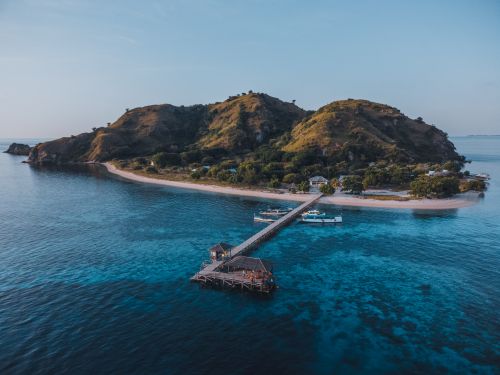 Free Aerial view of a scenic island with a pier in East Nusa Tenggara, Indonesia. Stock Photo