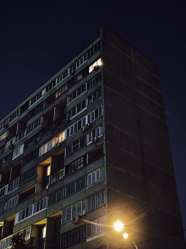 A Low Angle Shot Of An Apartment Building At Night