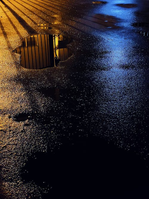 Black Asphalt Road with Puddle during Night Time