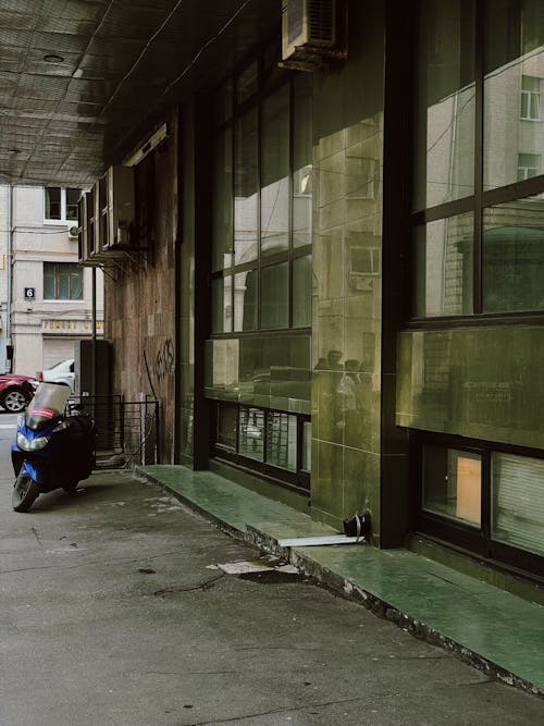 A Motorcycle Parked Near Glass Windows