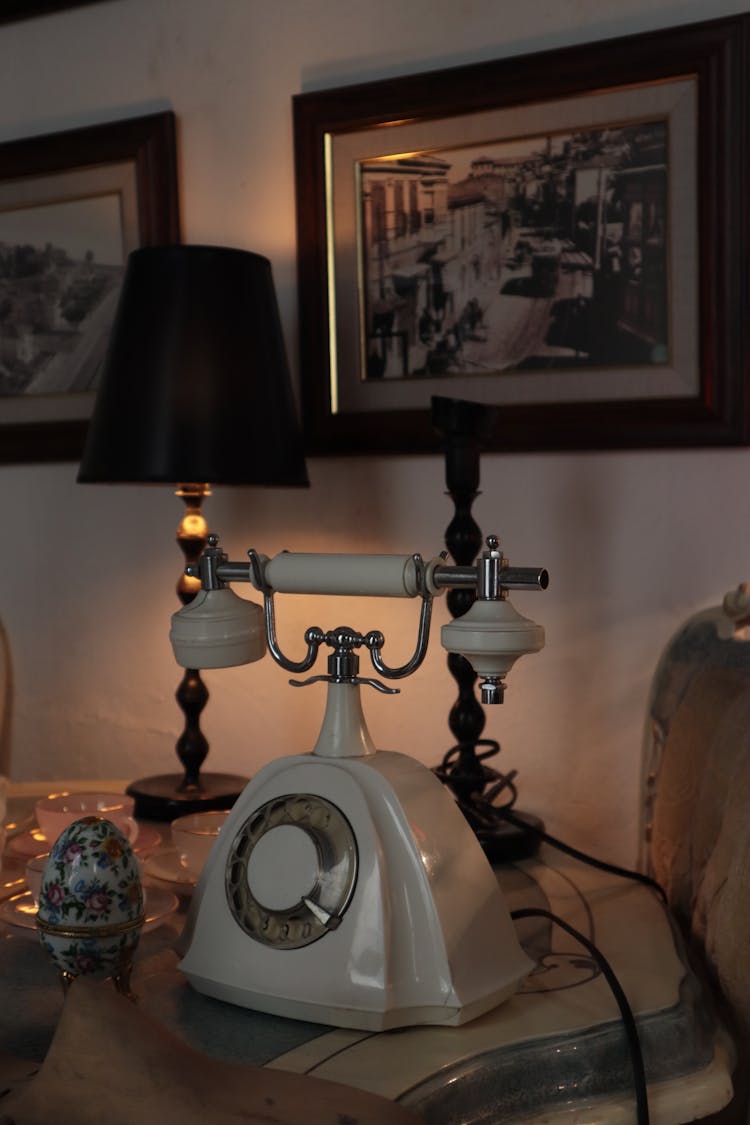 White Vintage Rotary Phone On Marble Top Table