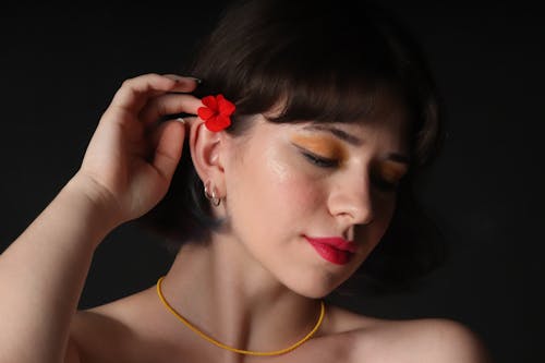 Woman with Red Flower on Ear