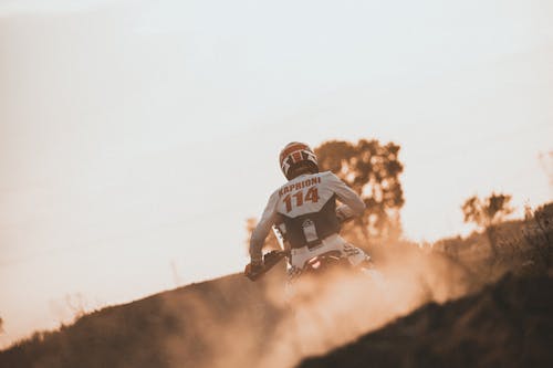 Motocross Rider Wearing Safety Gear while Strolling on the Road