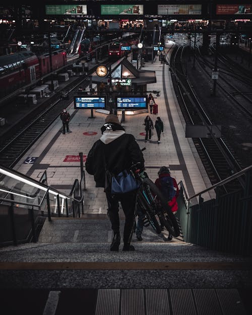 Passengers Going Down the Stairs of Train Station