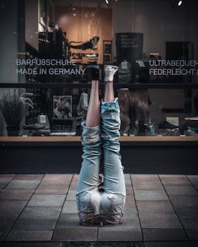 Unique upside-down denim jeans display in a Hamburg storefront with German signage.