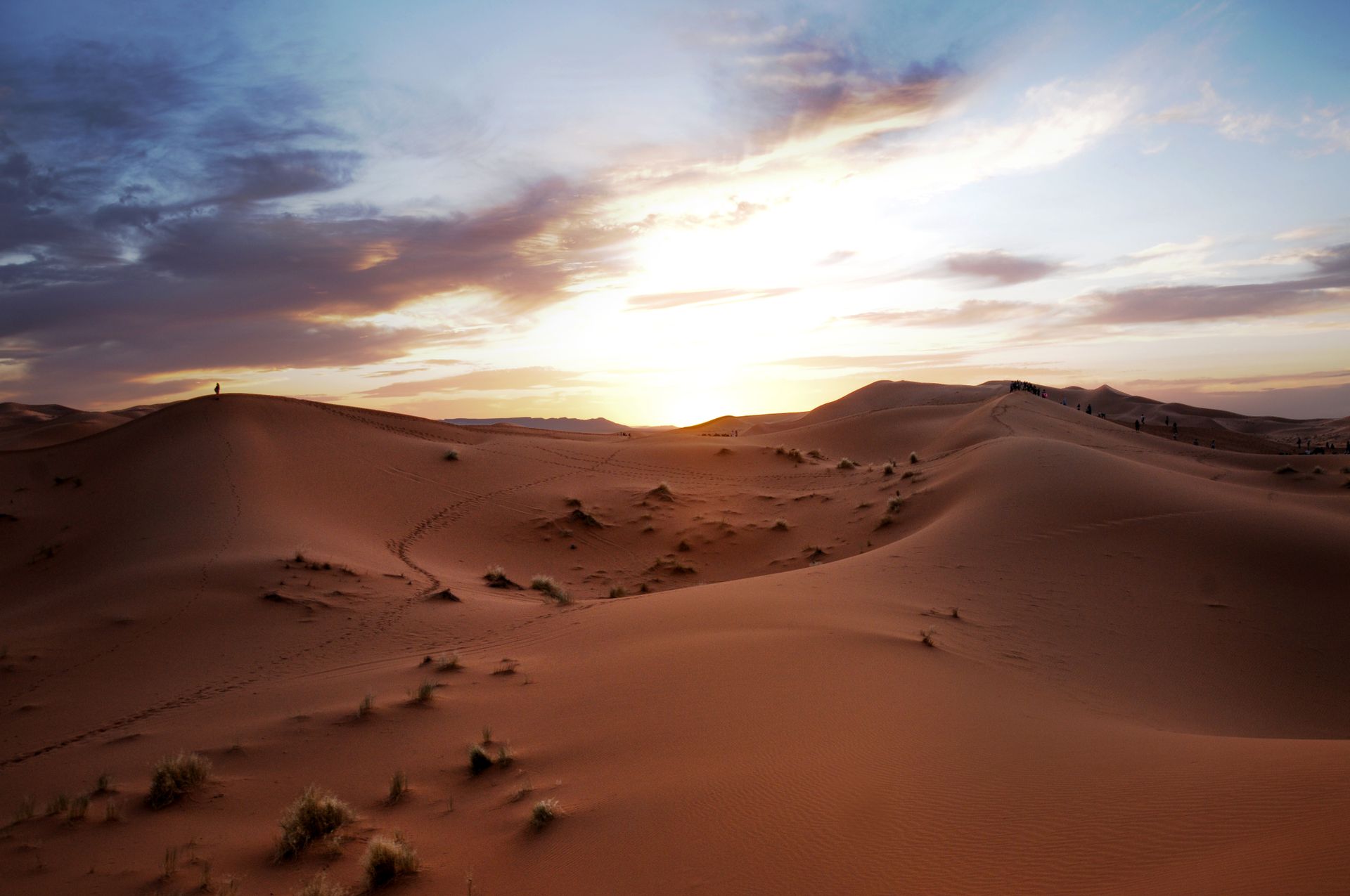 Stunning sunset over the rolling dunes of the Sahara Desert in Morocco.
