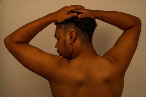 Back View of a Man with His Hands on His Head