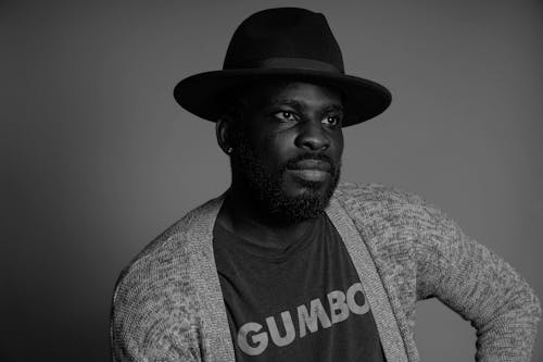 Grayscale Photograph of a Man with a Beard Wearing a Hat