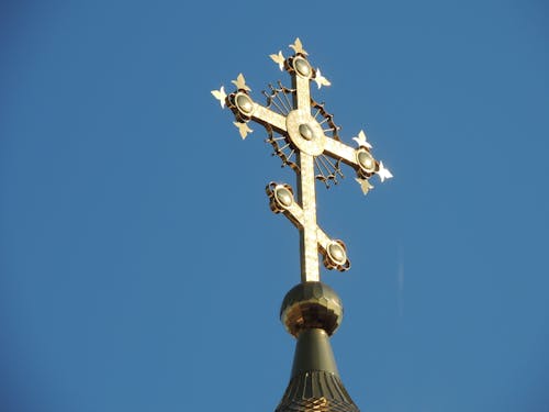 Low Angle Shot of Metal Cross under Clear Blue Sky 