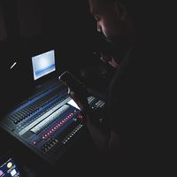 Mixing desk in a dim control room — photo by Abdullah Alsaibaie on Pexels