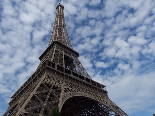 Free Low Angle Shot of Eiffel Tower Under Blue Sky with Thick Clouds Stock Photo