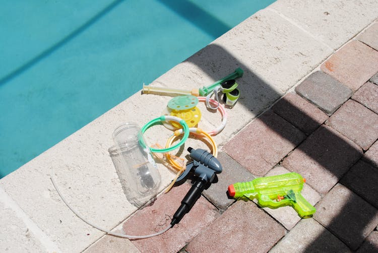 Assorted Plastic Toys On The Poolside