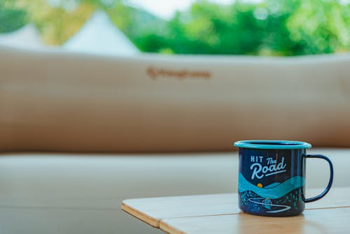 Blue and White Cup on Wooden Table