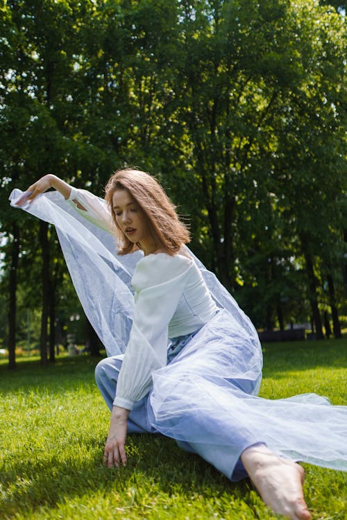 Photograph of a Girl Posing with a Sheer Fabric