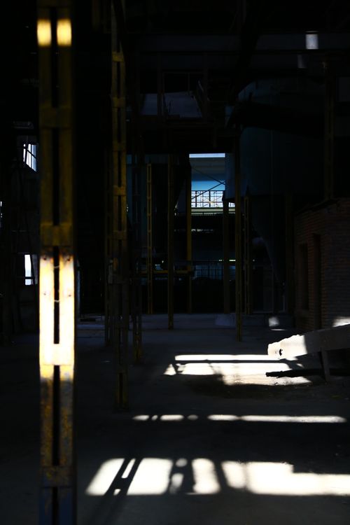 Free Moody interior of an abandoned factory with stark contrasts of light and shadow. Stock Photo