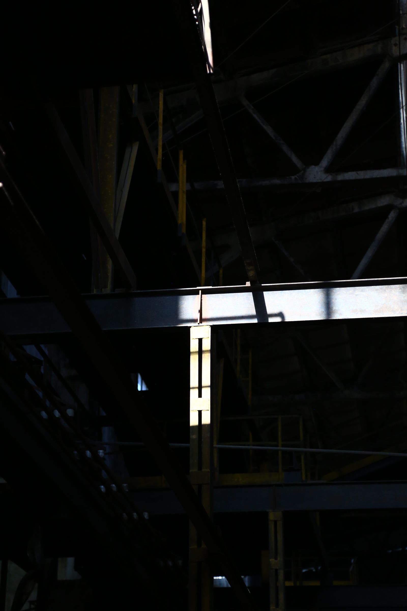 A warehouse interior mid fit-out with exposed beams and scaffolding