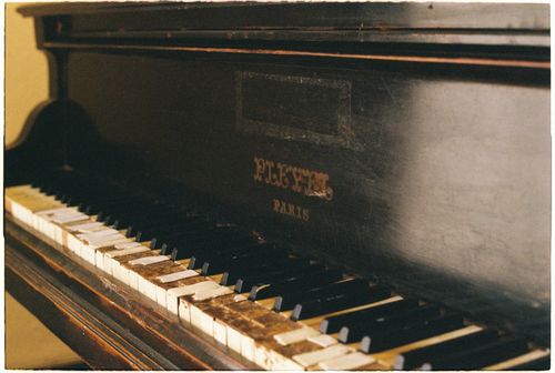Free Close-up view of an antique Pleyel piano showcasing its worn keys and vintage charm. Stock Photo