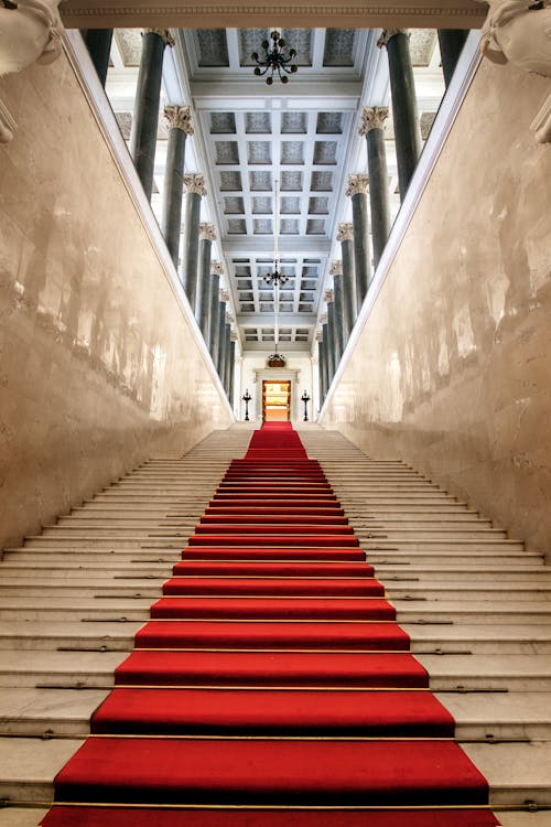 Free Red Carpet on Gray Concrete Hallway Stock Photo