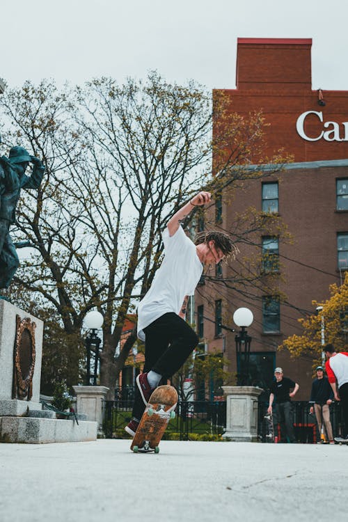 Free Man Doing a Trick on Skateboard Stock Photo