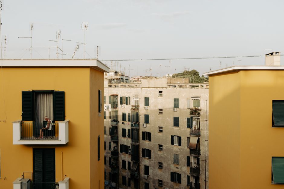 View of residential buildings with balconies, featuring serene urban living.