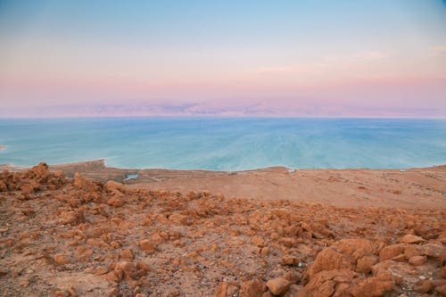 Brown Rocky Shore Near Body of Water