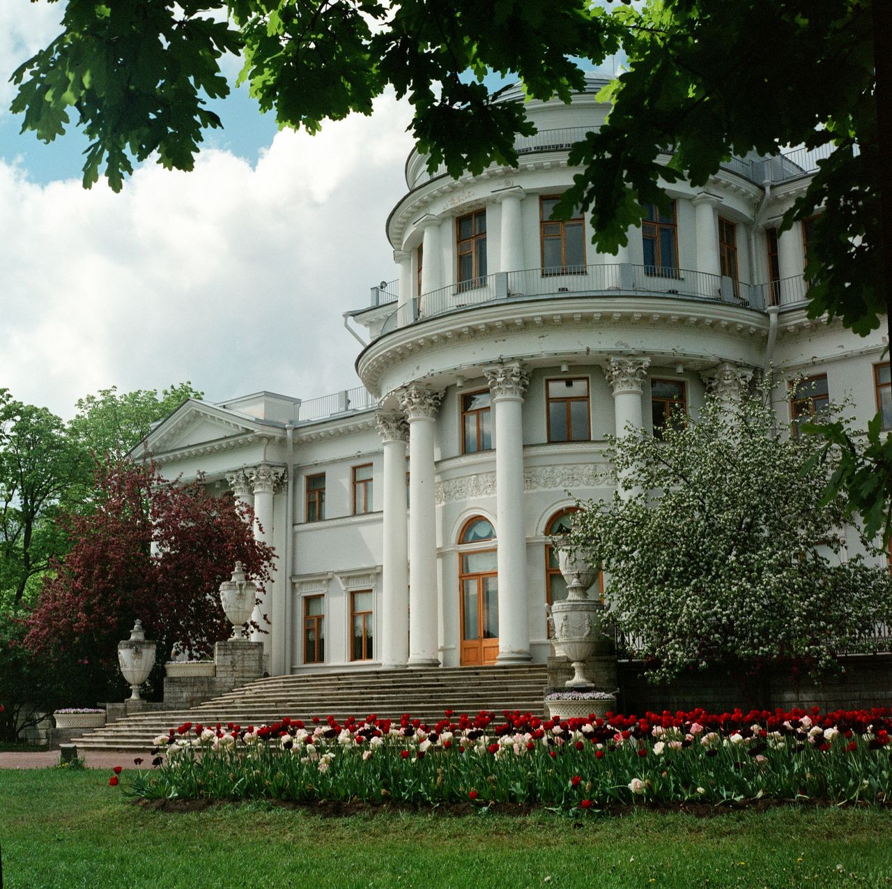 Grand mansion surrounded by vibrant garden