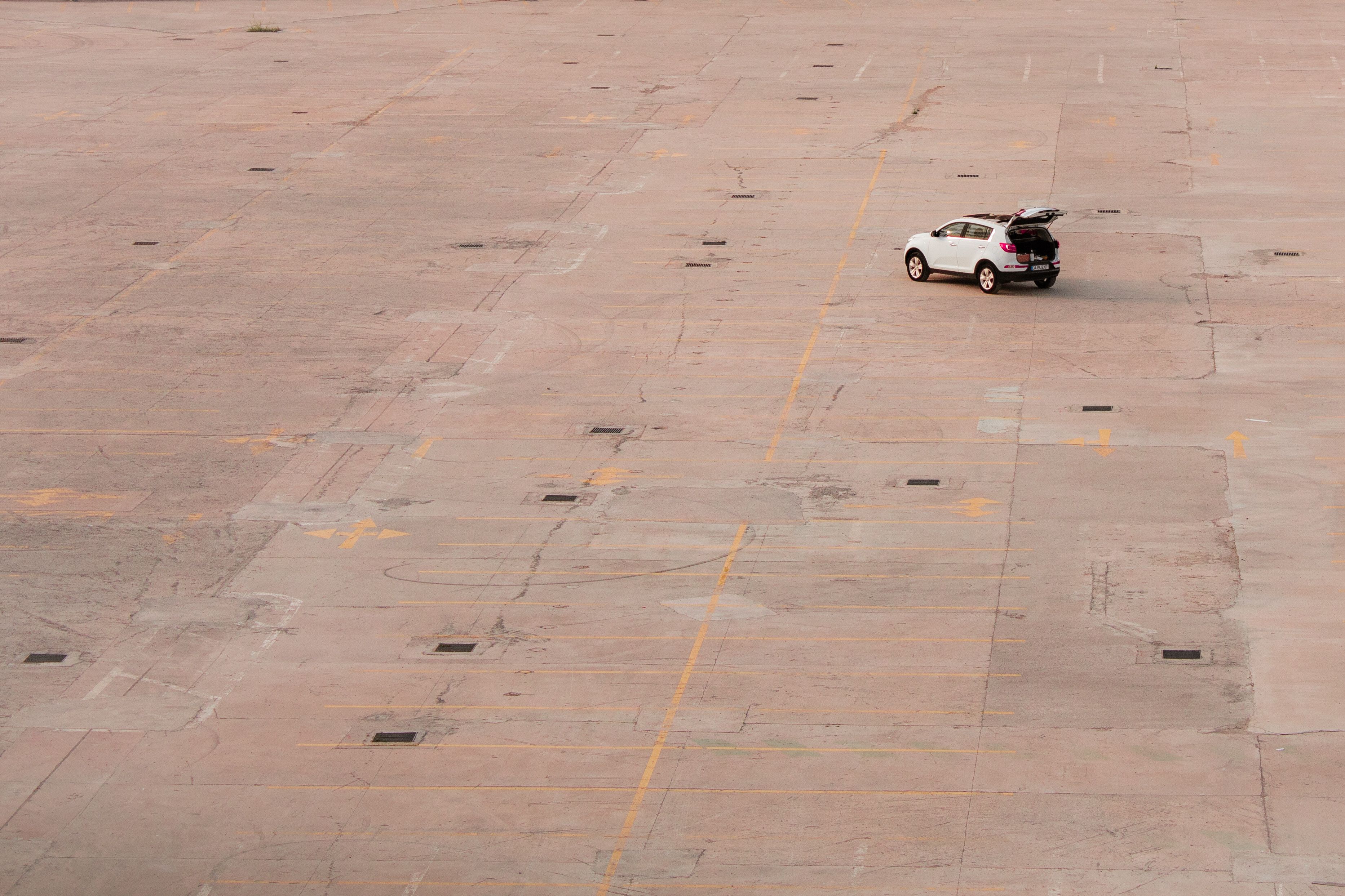 empty car factory parking lot with unfinished vehicles