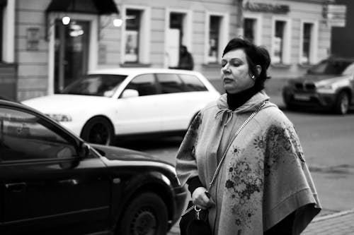 Black and White Photo of Elegant Woman Walking down Street