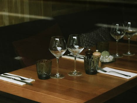 A stylish restaurant table set with wine glasses and cutlery, perfect for dining ambience.