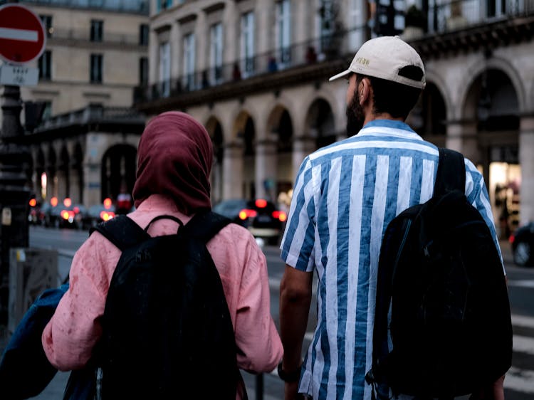 Man And Woman Walking With Backpacks