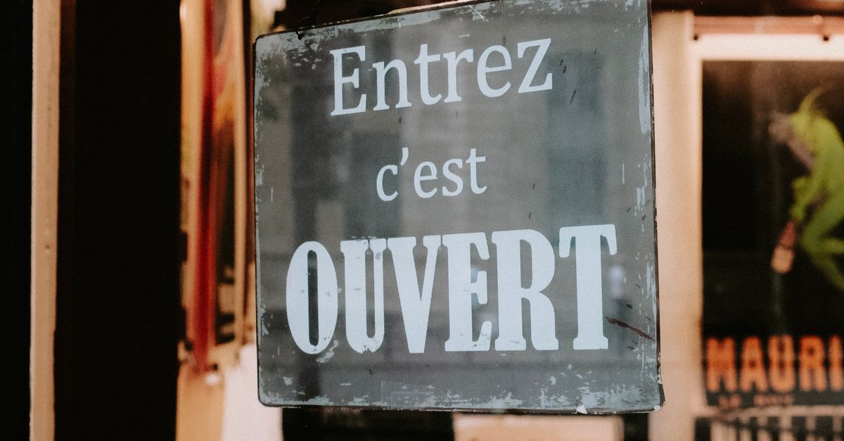 Hanging Window Sign Sign Hanging on Window in Store · Free Stock Photo