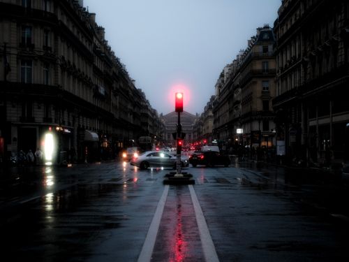 Free Rainy evening cityscape with wet streets and cars at a red traffic light. Stock Photo