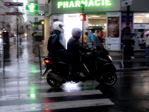 A Man in Black Jacket Riding Black Motorcycle