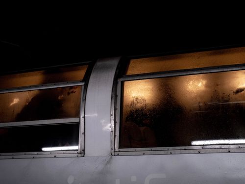 Free Dark subway train window with steamy reflections and interior lights glowing at night. Stock Photo