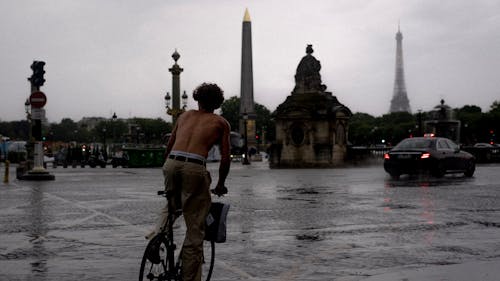 A Man Riding a Bicycle Shirtless